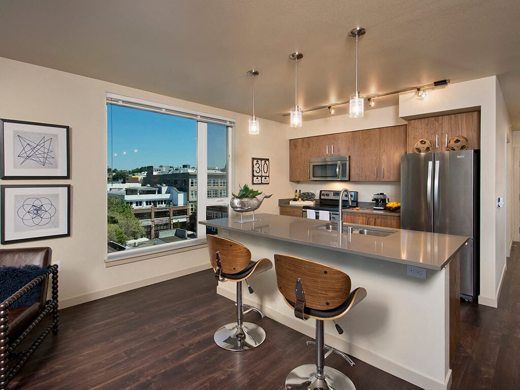 A modern kitchen and kitchen island at the Infinity Apartments in Seattle, Washington.